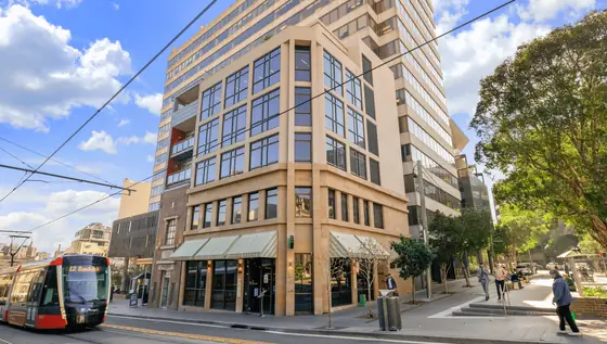 Exterior of a building with orange awnings and a sign above the door that reads “Prospect.”
