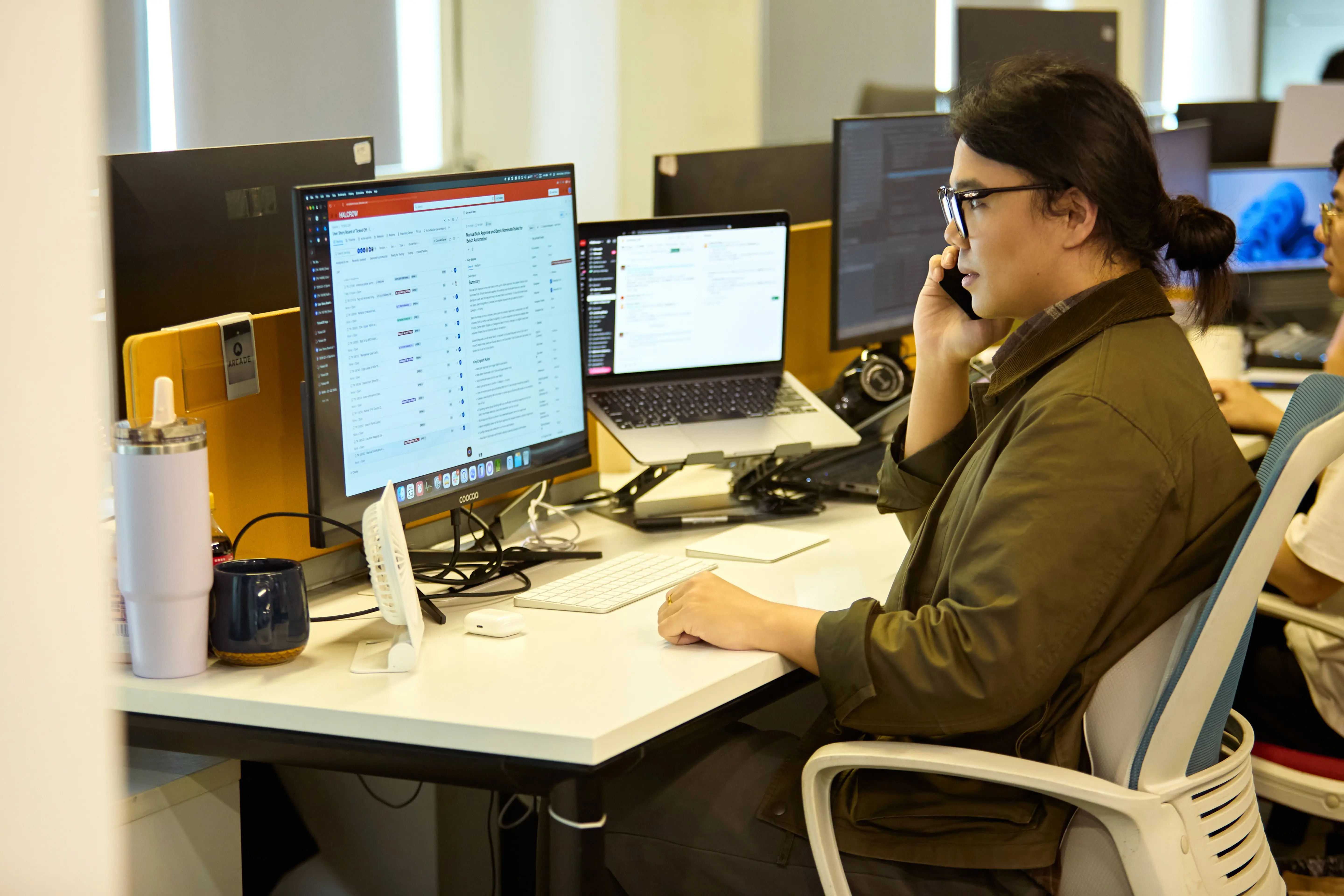 A Halcrow engineer on a call at a two-monitor desk